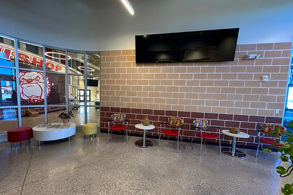 Multiple chairs with small tables in a common area