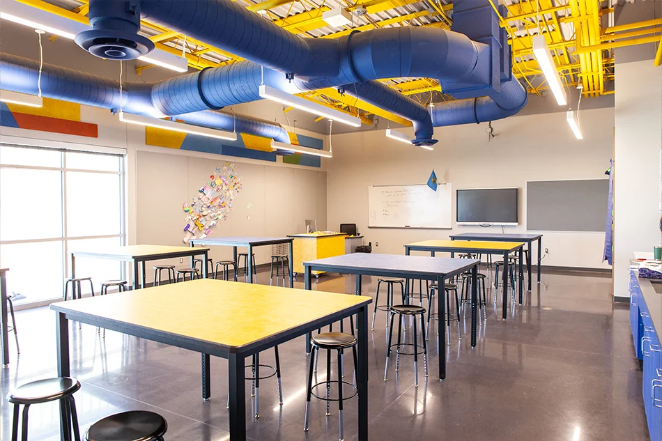 Several group tables in a science lab classroom