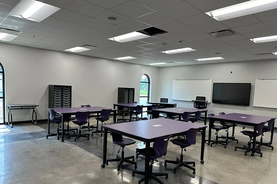 A classroom with group seating tables