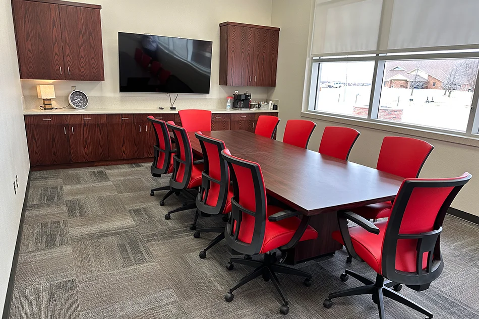 A conference room at Weatherford Public Schools with red chairs