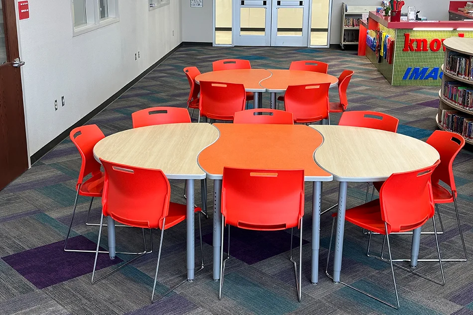 Two round tables with red chairs
