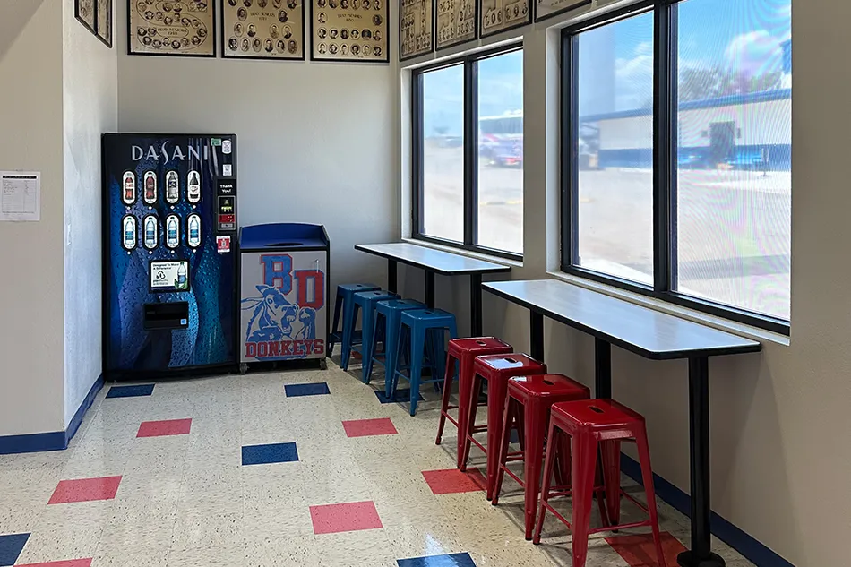 Student tables in front of a window with a large red bulldog decal