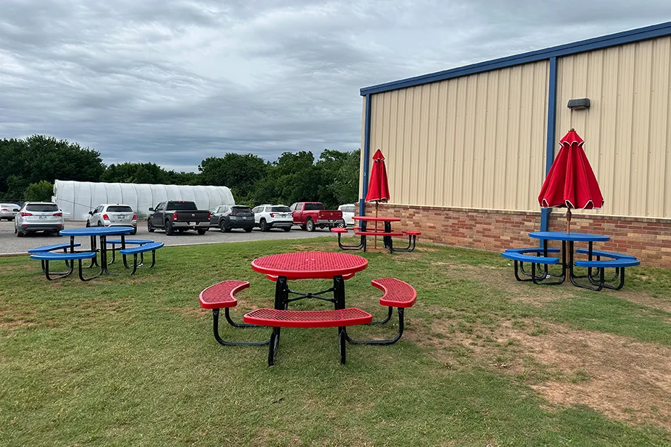 Student tables in front of a window with a large red bulldog decal