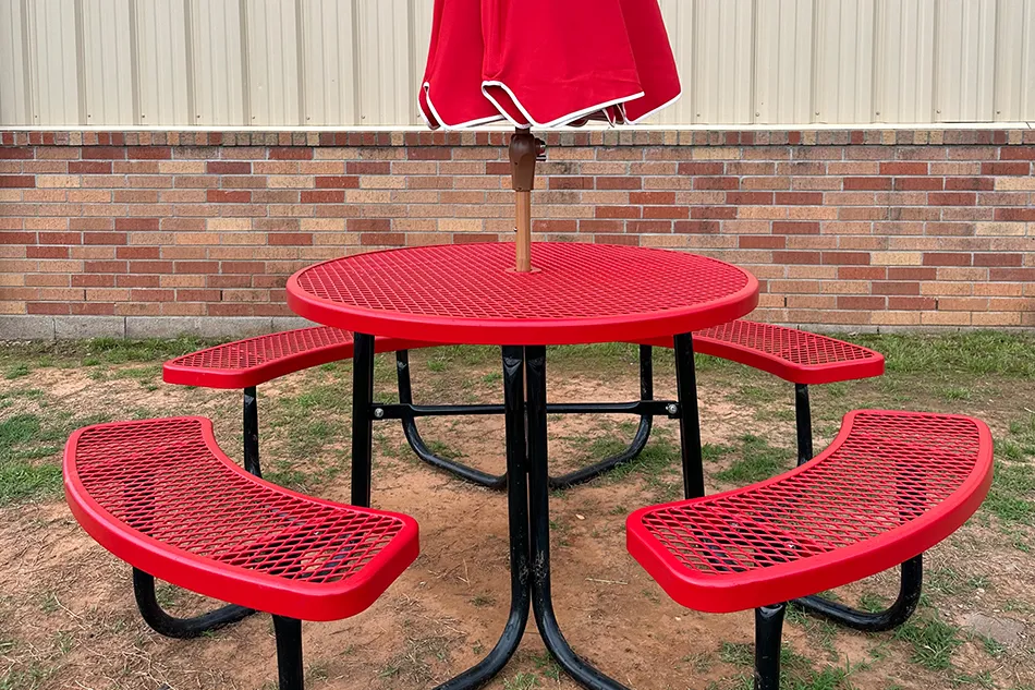 Student tables in front of a window with a large red bulldog decal