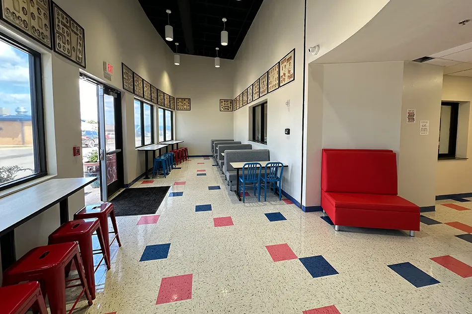 Student tables in front of a window with a large red bulldog decal