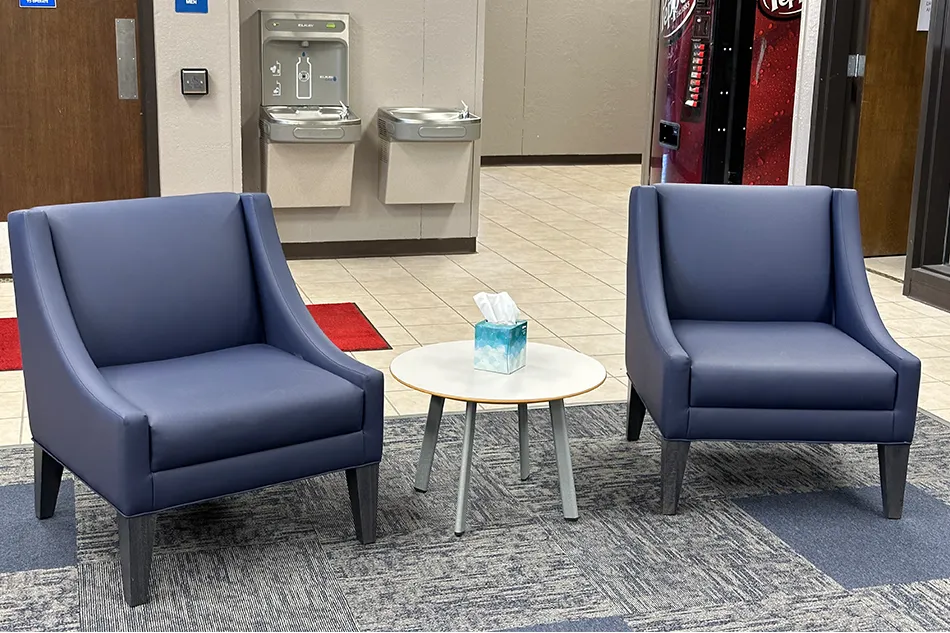 Student tables in front of a window with a large red bulldog decal