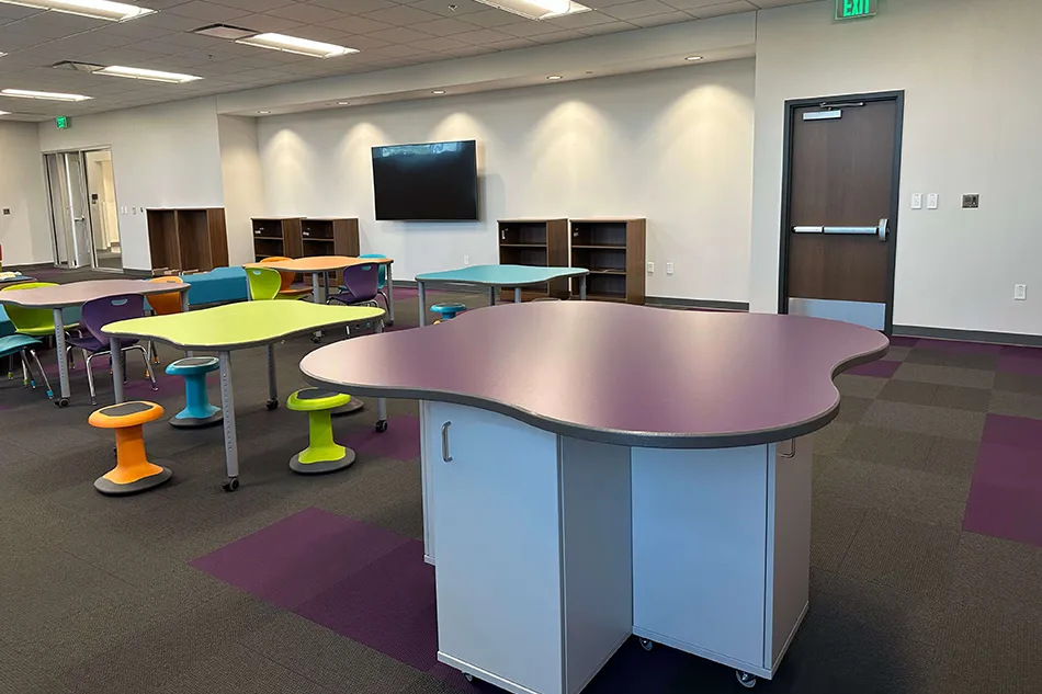 Multiple chairs with small tables in a common area