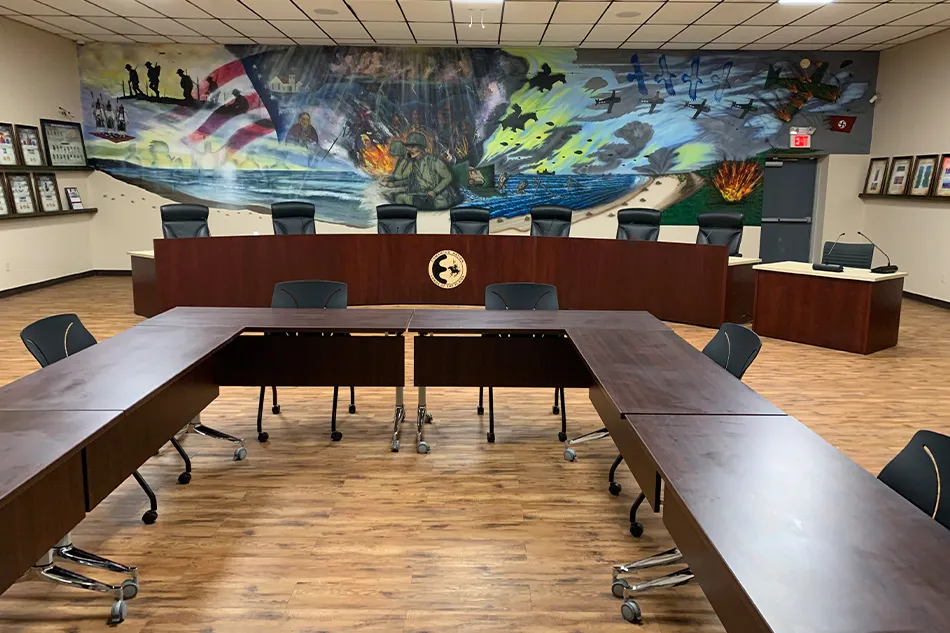Multiple chairs with small tables in a common area
