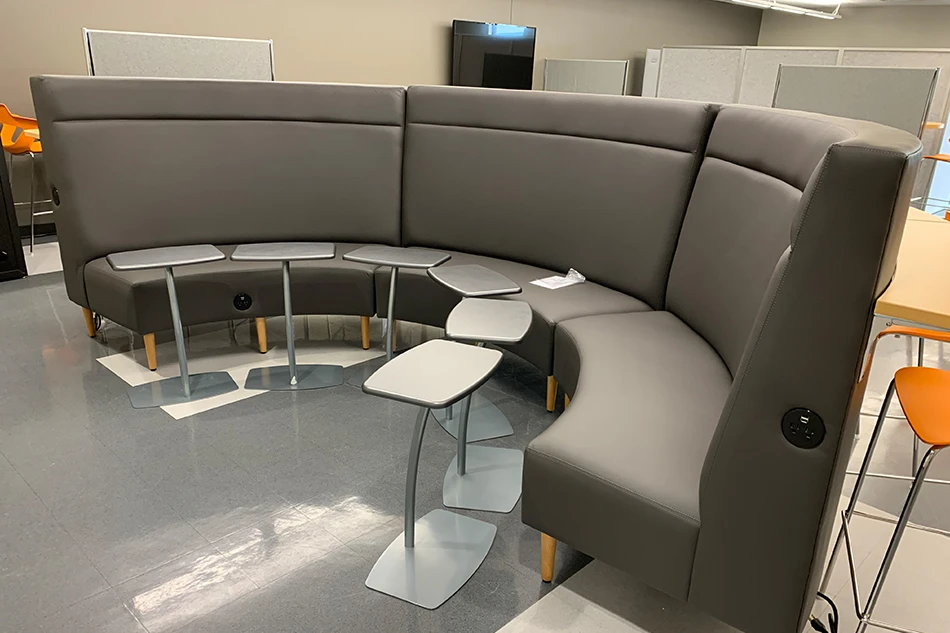 Multiple chairs with small tables in a common area