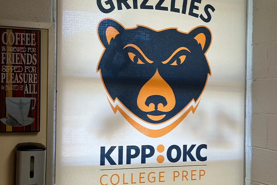 Student tables in front of a window with a large red bulldog decal