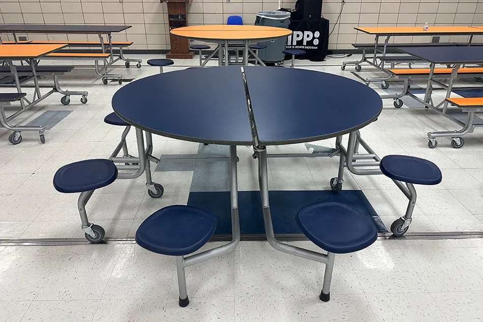 Student tables in front of a window with a large red bulldog decal