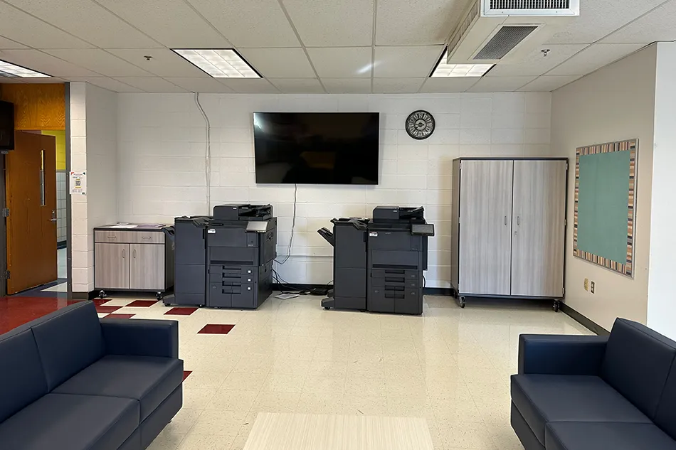 Student tables in front of a window with a large red bulldog decal