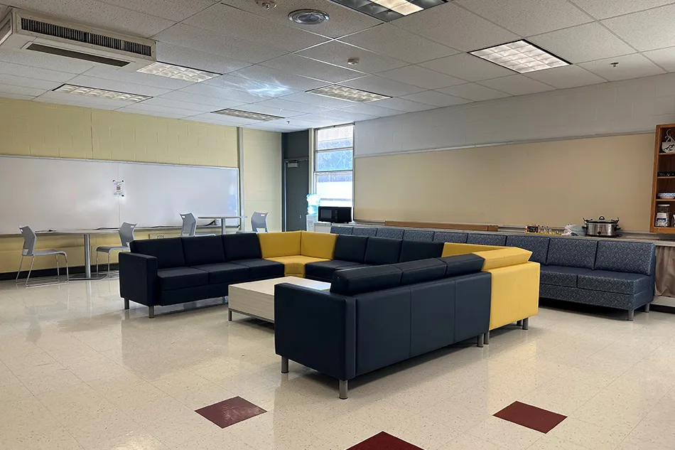 Multiple chairs with small tables in a common area