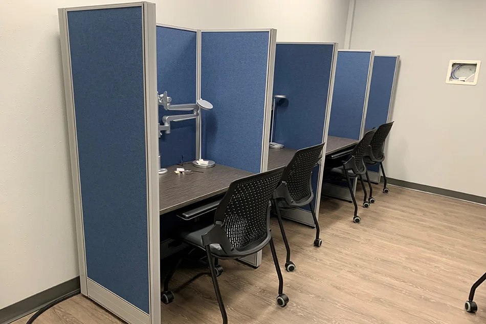 Multiple chairs with small tables in a common area