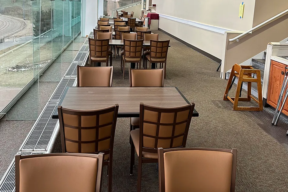 Multiple chairs with small tables in a common area