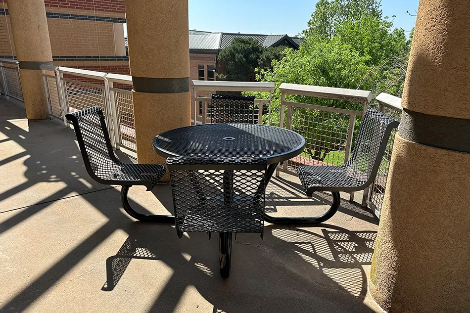 Student tables in front of a window with a large red bulldog decal