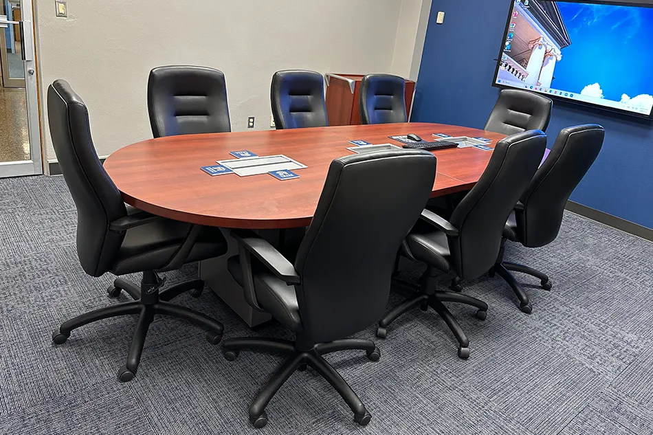 Multiple chairs with small tables in a common area