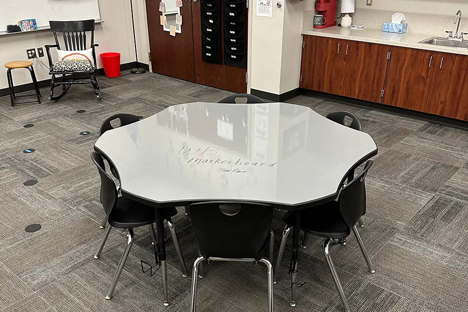 Group tables with silver stools in a lab