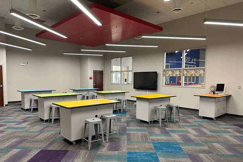Student tables in front of a window with a large red bulldog decal