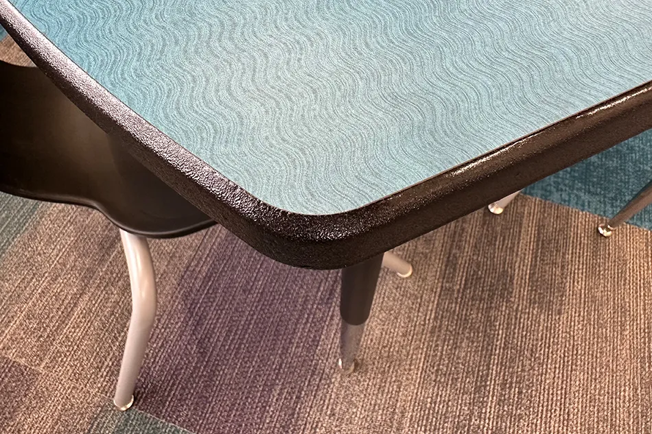 Group tables with silver stools in a lab