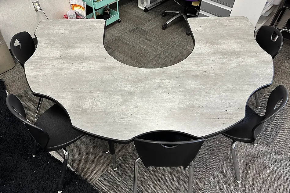 A sitting booth next to a trash can