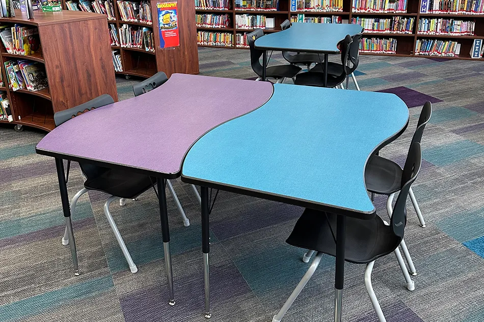 A sitting booth next to a trash can