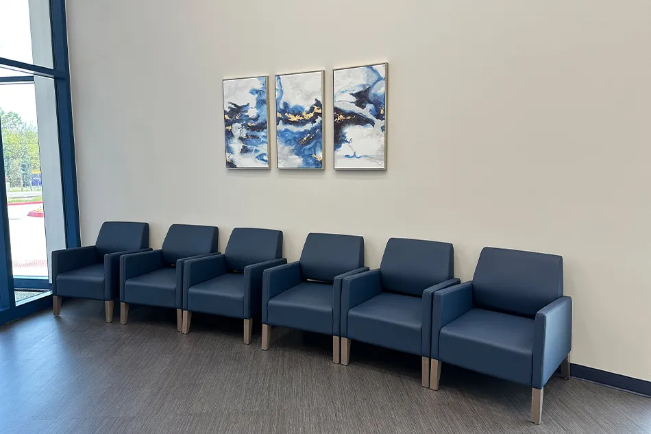 Multiple chairs with small tables in a common area
