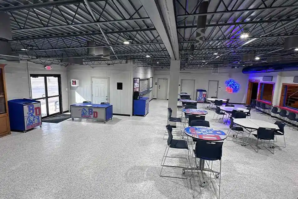 An outdoor trash can with a red bulldog