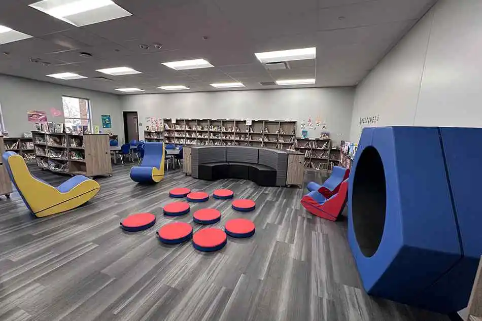 Student tables in front of a window with a large red bulldog decal